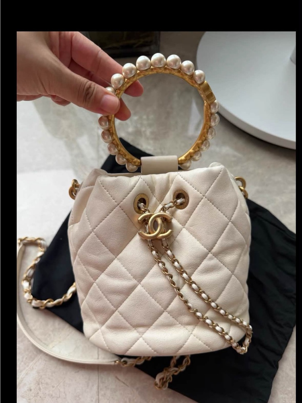 CHANEL Cream Quilted Mini Bucket Bag with Pearl-Embellished Handle